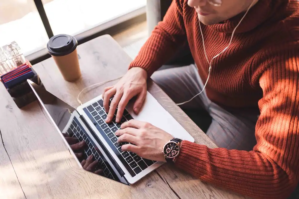 man on laptop writing a blog article